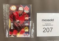 Front view of sealed 1997-98 Team Canada Wayne Gretzky $5 phone card showing image of player in Team Canada uniform with Olympic logo and $5 denomination.