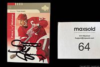 Front of autographed Steve Yzerman 2002-03 Upper Deck hockey card showing image of Yzerman in red Detroit Red Wings uniform with autograph in black Sharpie