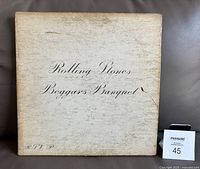 Front white gatefold cover of The Rolling Stones Beggar's Banquet album with wear and discoloration.