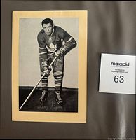 Front of Beehive photo showing Larry Regan on manila backing with MaxSold lot tag