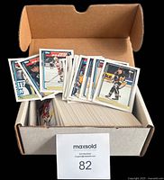 Open card storage box showing large stack of cards with several cards fanned on top