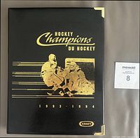 Front of black Kraft Hockey Champions album with gold graphics