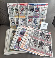 Stack of uncut sheets showing front player images