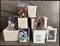 Five card boxes with sample cards displayed: Steve Young Absolute Playoff, John Elway Fleer Brilliants, others front