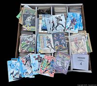 Monster box with four rows of stacked football cards and selection of inserts displayed on top