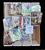 Top view of monster box showing rows of 1999 NFL cards packed tightly with several sample cards displayed on top