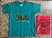 Full view of teal Sacramento Gold Miners T-shirt beside red Hall of Fame bag