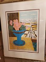 Framed print showing the full artwork of flowers in vase and landscape outside the window.