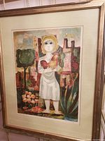 Framed print showing a stylized young girl holding a bird with abstract background and earth tones