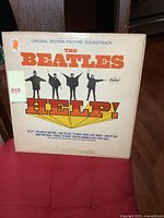 Front cover of The Beatles Help! vintage LP album showing the title, silhouettes of the band members, and Capitol Records logo.