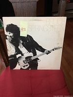 Front cover of Bruce Springsteen Born to Run album, showing Bruce with guitar in black and white.