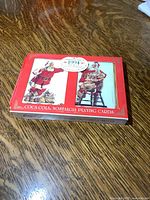 Red collectible tin box featuring 1994 Coca-Cola Nostalgia Playing Cards with vintage Santa Claus artwork