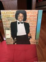 Front cover of Michael Jackson Off The Wall vinyl LP showing artist in tuxedo against brick wall.