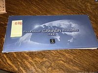 Blue rectangular box labeled 'Millennium Canada 2000' with globe image on top, slight edge wear visible.