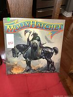 Front cover of Molly Hatchet vintage LP showing cover art with armored knight on horse.