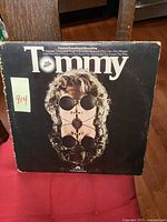 Front cover of vintage The Who Tommy LP album showing wear and seam tear on edge with sticker label 914