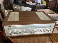 Front view of Yamaha CR-820 receiver showing faceplate, knobs, switches and wood cabinet