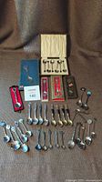 Photo showing the entire collection laid out including boxed spoons, loose spoons, and spoons in packaging.
