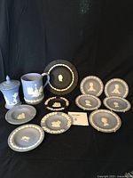 Full lot of 11 Wedgwood Jasperware items including plates, mug, and covered trinket vessel arranged for display