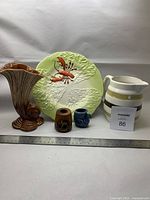 Full view of all items including vase, plate, pitcher, and two toothpick holders with ruler for scale