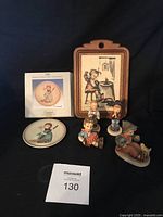 Full set of 4 mini Hummel figurines, collector's plate, and wall plaque displayed together on black background