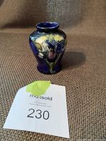 Mini Walter Moorcroft ceramic vase with blue background and orchid floral design