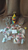 Full lot showing Minnie Mouse glass mug, Mr. Elephant puzzle tube, Mickey Mouse McDonald's 2000 plastic cup, and spread of 32 individually packaged vintage Christmas ornaments.