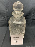 Front view of vintage lead crystal square decanter with faceted stopper in place, showing Star of David and geometric patterns in the cut glass.