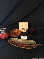 Photo showing all items in the lot: Canadian Pottery vase, Royal Haeger leaf dish, two glass side dishes, and cookbook box.