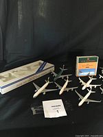 Lot of vintage metal scale model airplanes displayed with original packaging, varied airline liveries including Air Canada, Air Malaysia, Cathay Pacific, Canadian Air.