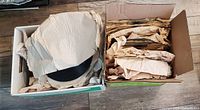 Two boxes containing over 70 vintage records, some wrapped in paper for protection, viewed from top.