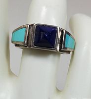 Close-up front view of 925 sterling silver ring featuring square lapis lazuli center stone and turquoise inlays.