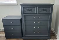 Wide view of highboy dresser and matching nightstand side by side showing overall design and color.