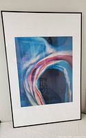 Front view of framed art print with colorful abstract shapes in blues and pinks.