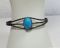 Front view of the sterling silver cuff bracelet with oval blue turquoise stone centered.