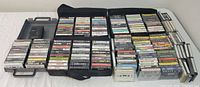 Wide view of all cassette tapes spread out with cases and portable player visible