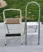 Photo showing both step stools side by side on a concrete surface with grass in background.