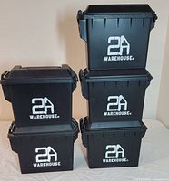 Five black stackable plastic military boxes with 2A Warehouse logos stacked and grouped