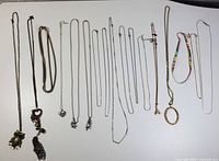 Full display of all necklaces and chains including articulated animal head pendants and various decorative pendants.