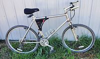 Full side view of silver Marin Eldridge Grade mountain bike showing frame, tires, handlebars, saddle, pedals, and water bottle cages.