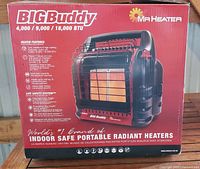 Box front showing BigBuddy portable radiant heater specs and features.