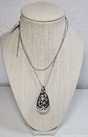 Full view of necklace on a display bust showing pendant and chain length.