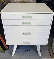 Front view of wooden 4 drawer painted side table with white paint and light green handles, showing overall condition and structure.