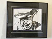 Front view of the framed black and white print depicting Gord Downie, signed by the artist.