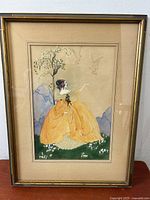 Frontal view of the framed watercolour painting of a lady in a yellow dress with doves, showing the full composition and framing.