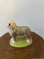 Front and side view of the Wade England Championship Series English Sheepdog ceramic figurine on a wooden surface.