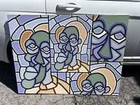 Front view of the large abstract floating heads oil painting on canvas leaning against a white vehicle, showing the full artwork and size reference.