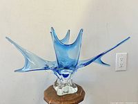 Front profile shot of the blue and clear glass splash bowl on its clear molded base.