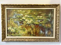 Full front view of framed oil painting depicting water lilies on pond surface