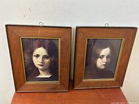 Two Victorian girl portraits in wood frames with brass inner borders, showing light wear on frames.